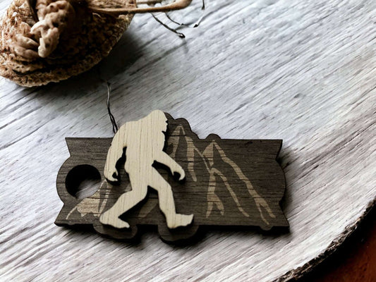 Wooden Sasquatch Mountains Tumbler Topper featuring a Sasquatch silhouette on a mountain backdrop by Boston Print Co.