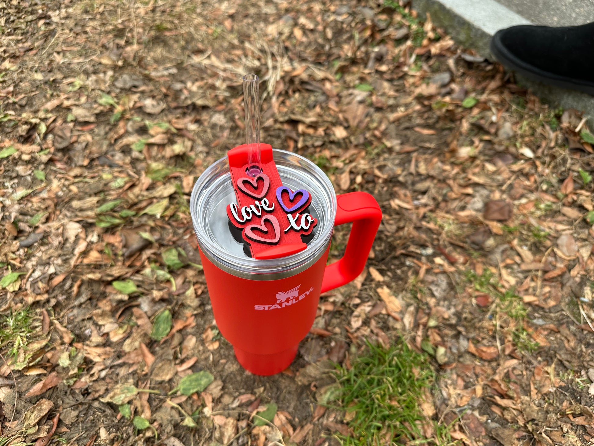 Radiant Red Wooden Tumbler Topper by Boston Print Co. on a cup in the grass