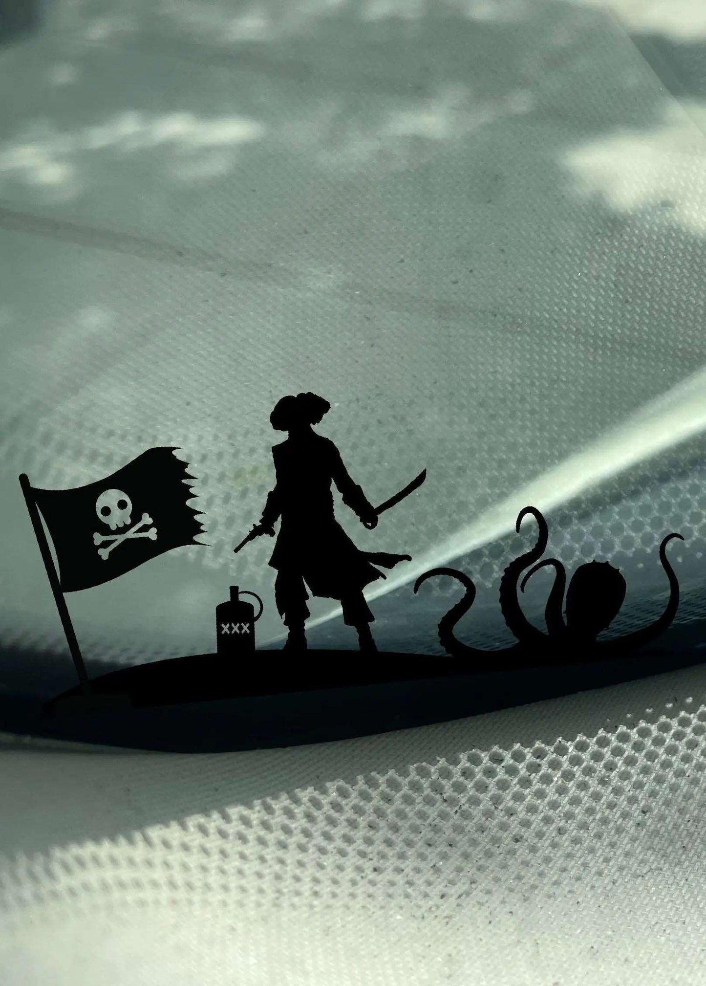 Pirate and Kraken Decal featuring a pirate flag, pirate holding a sword on a tiny island, and a kraken on the shoreline by Boston Print Co