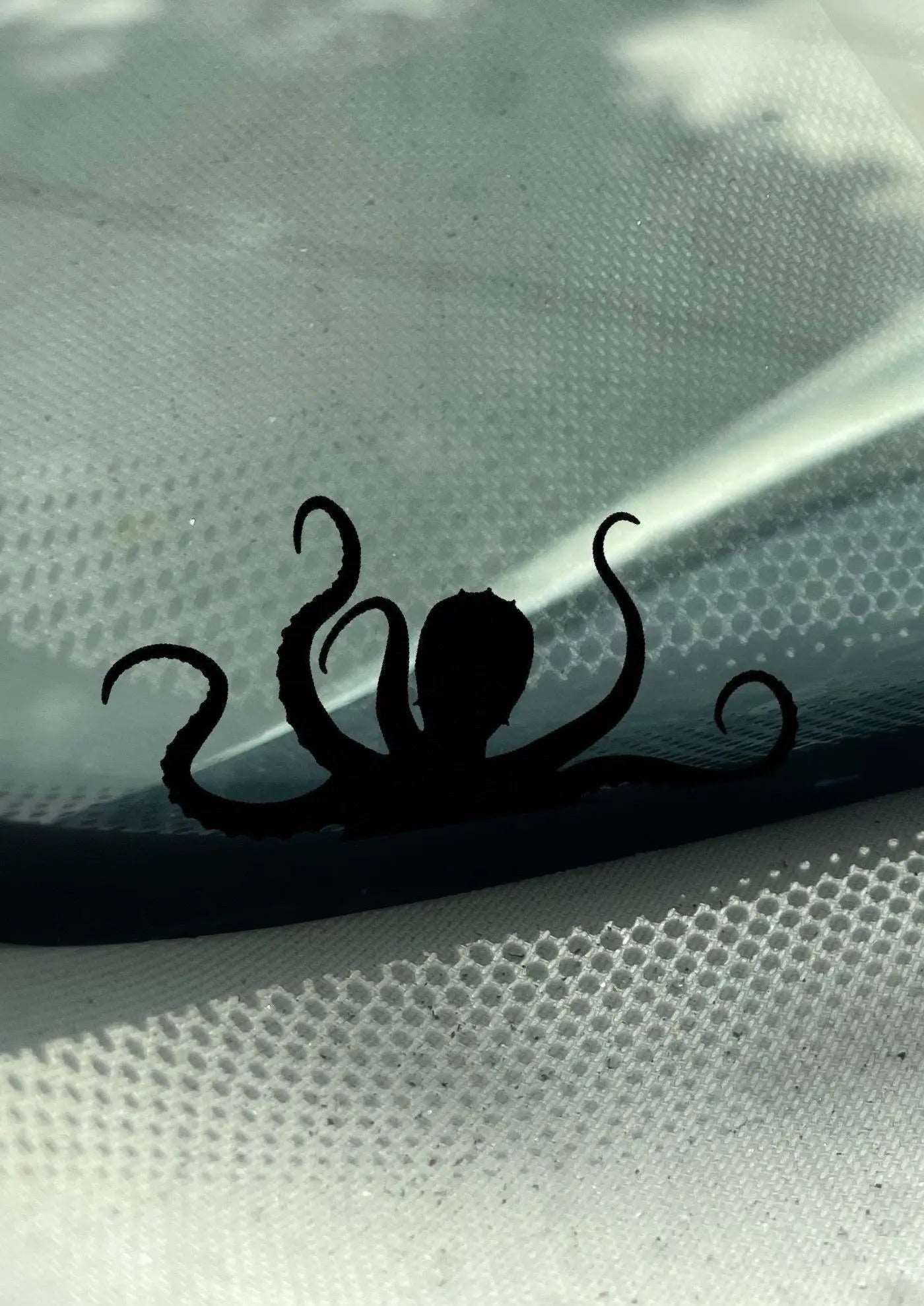 Small Kraken Decal by Boston Print Co. on a car windshiled