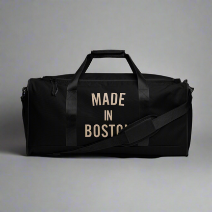 "Made in Boston" duffle bag, 100% polyester, adjustable padded shoulder strap, dual padded handles, mesh side pocket, and multiple inside pockets.