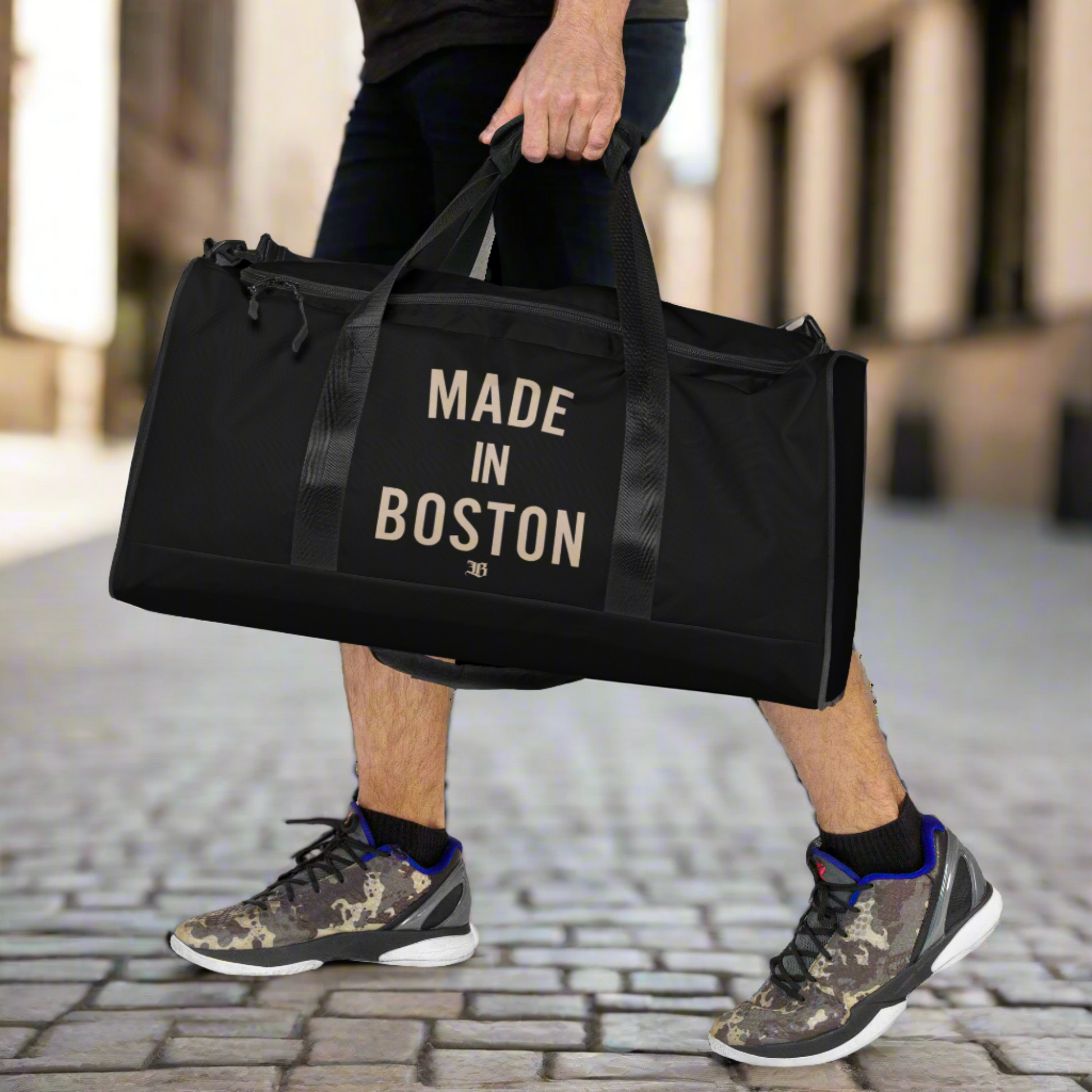 "Made in Boston" duffle bag, 100% polyester, adjustable padded shoulder strap, dual padded handles, mesh side pocket, and multiple inside pockets.