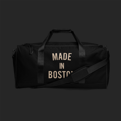 "Made in Boston" duffle bag, 100% polyester, adjustable padded shoulder strap, dual padded handles, mesh side pocket, and multiple inside pockets.