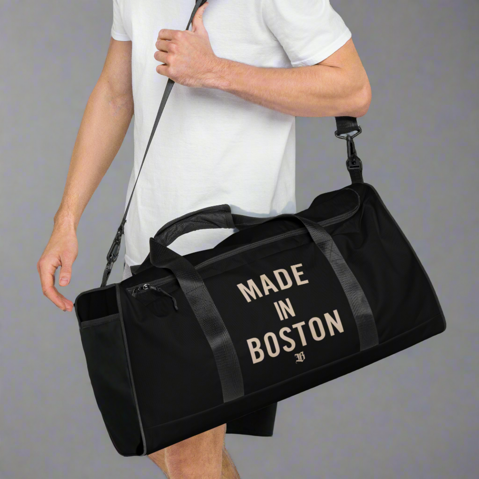 "Made in Boston" duffle bag, 100% polyester, adjustable padded shoulder strap, dual padded handles, mesh side pocket, and multiple inside pockets.